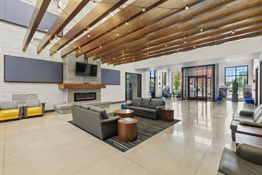 Atrium located in the Moore Center, showing seating, a television, and a shared space